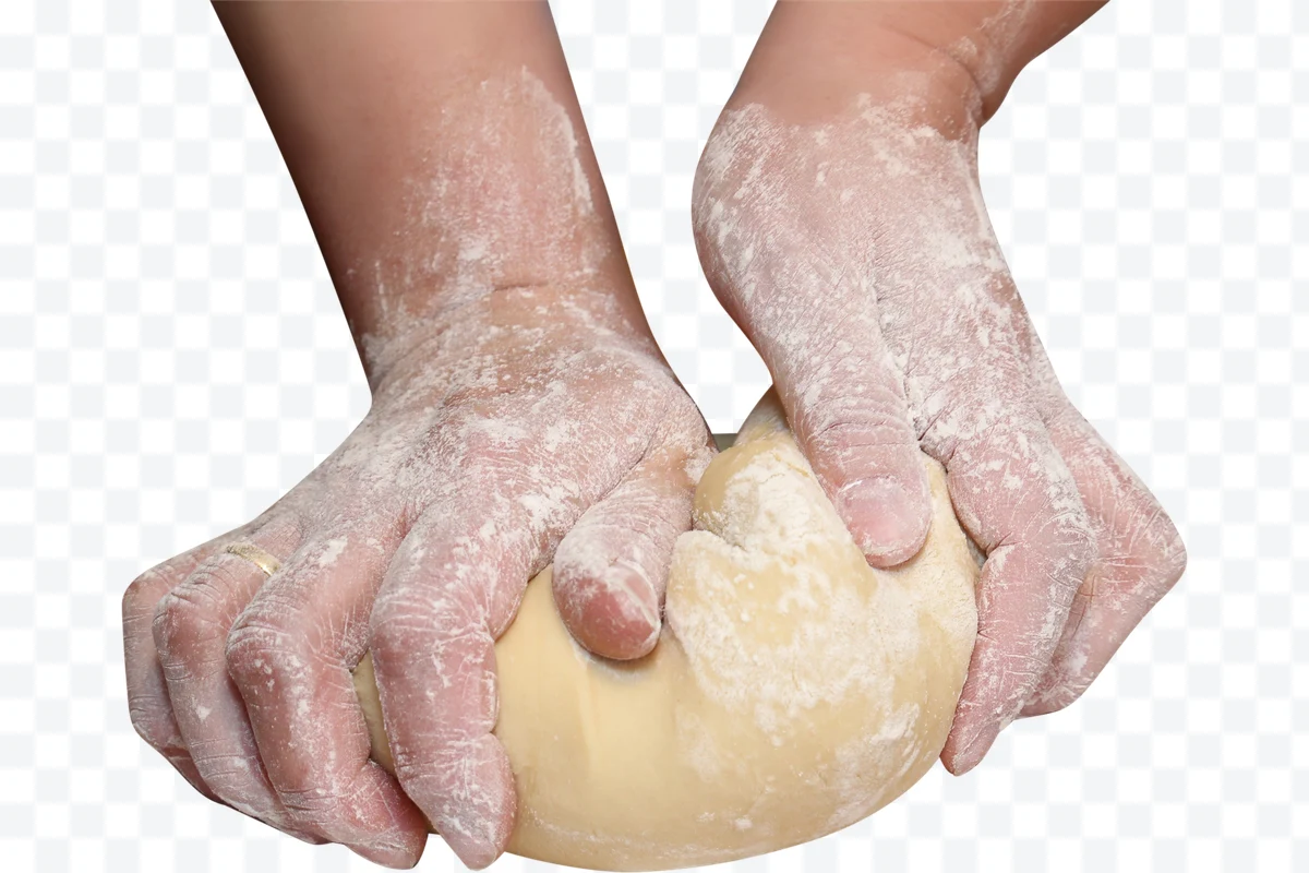 Hands with flour kneading bread dough