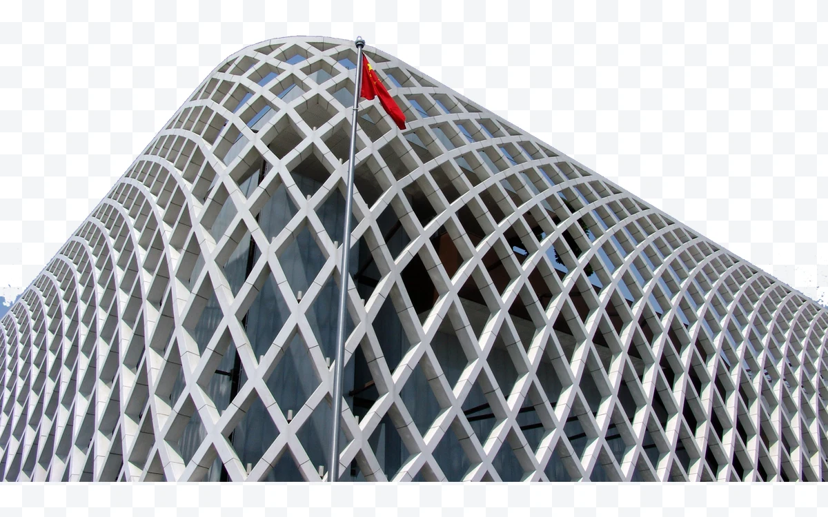 Building with white lattice facade and red flag