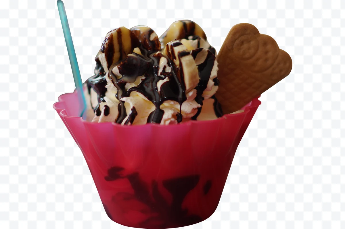Ice cream with whipped cream, banana, chocolate, and cookie