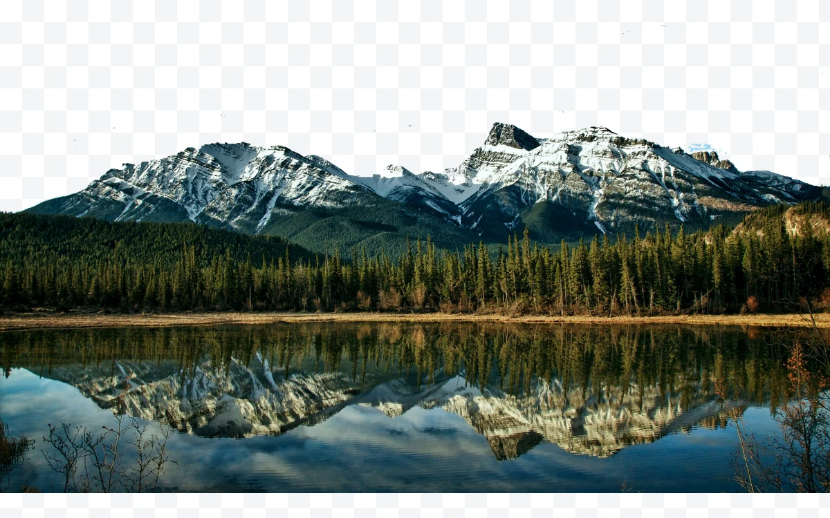 Snowy mountains with forest and reflecting lake
