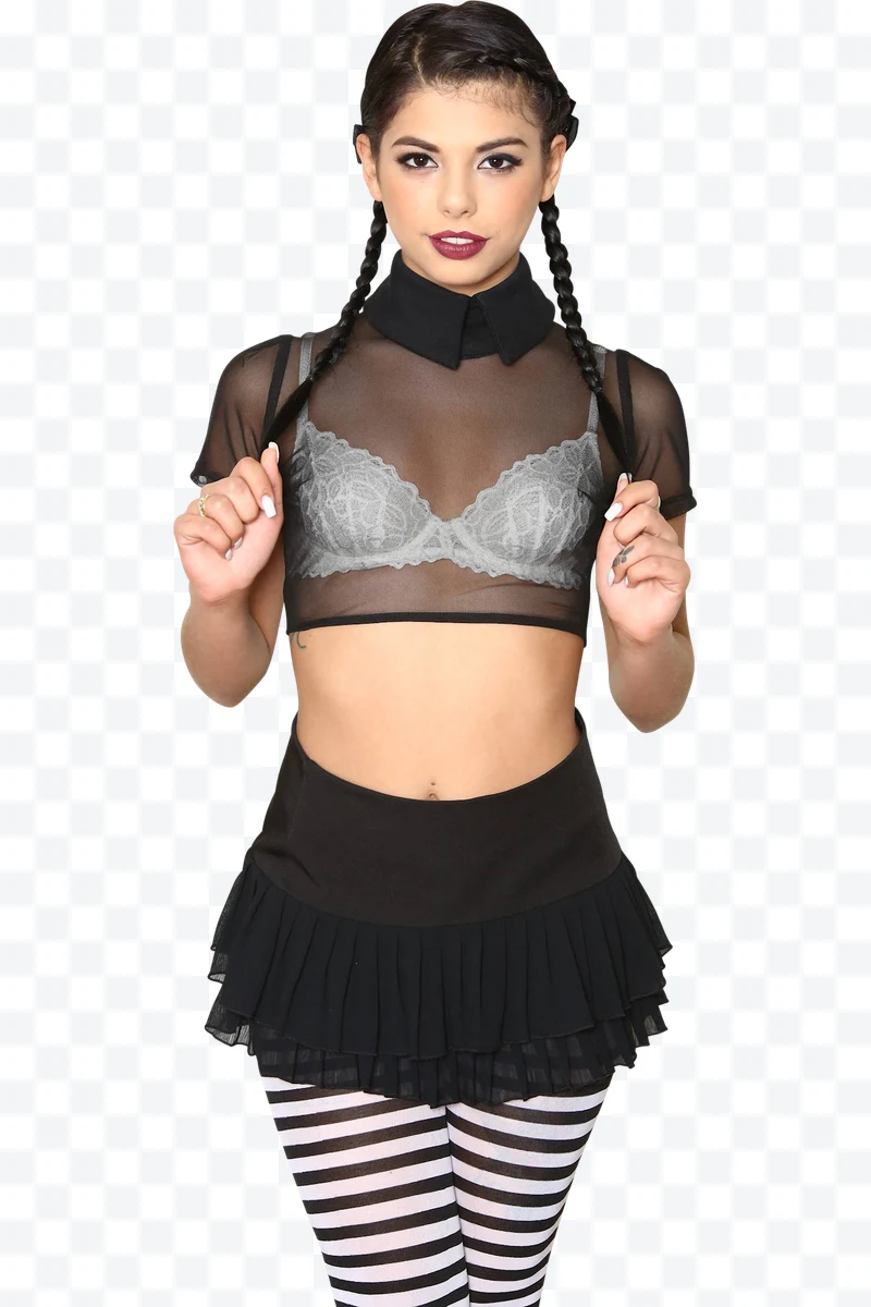 Woman with braids and black clothing with striped tights posing facing forward