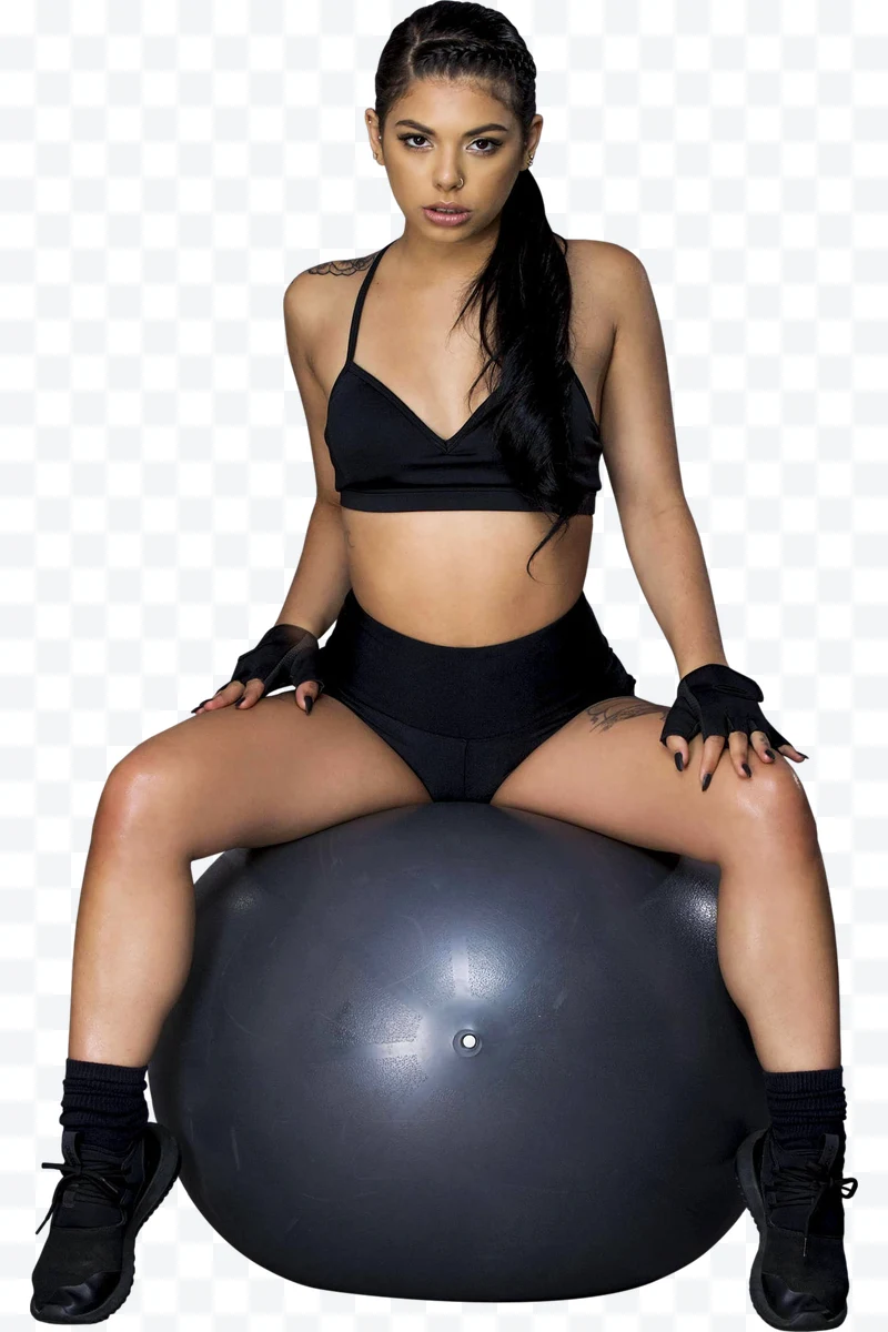 Young woman in black sportswear sitting on a gray exercise ball.