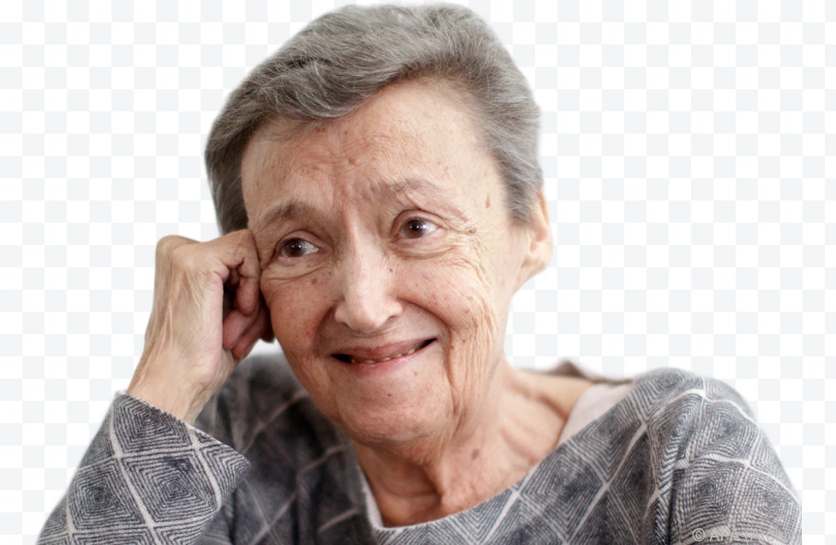 Smiling older woman in gray sweater resting her head on her hand