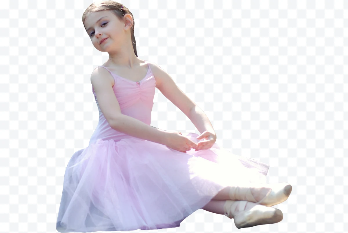 Girl ballerina in pink dress with lace sitting