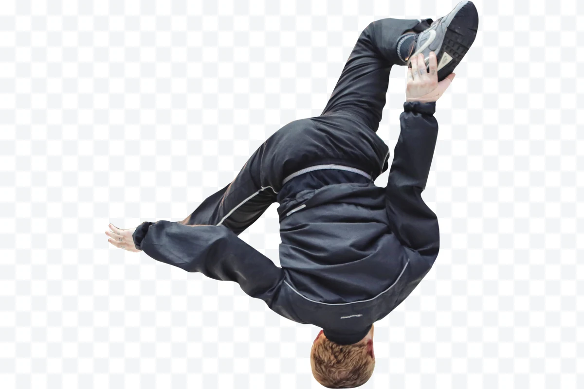 Person doing acrobatics in black sportswear and sports shoes