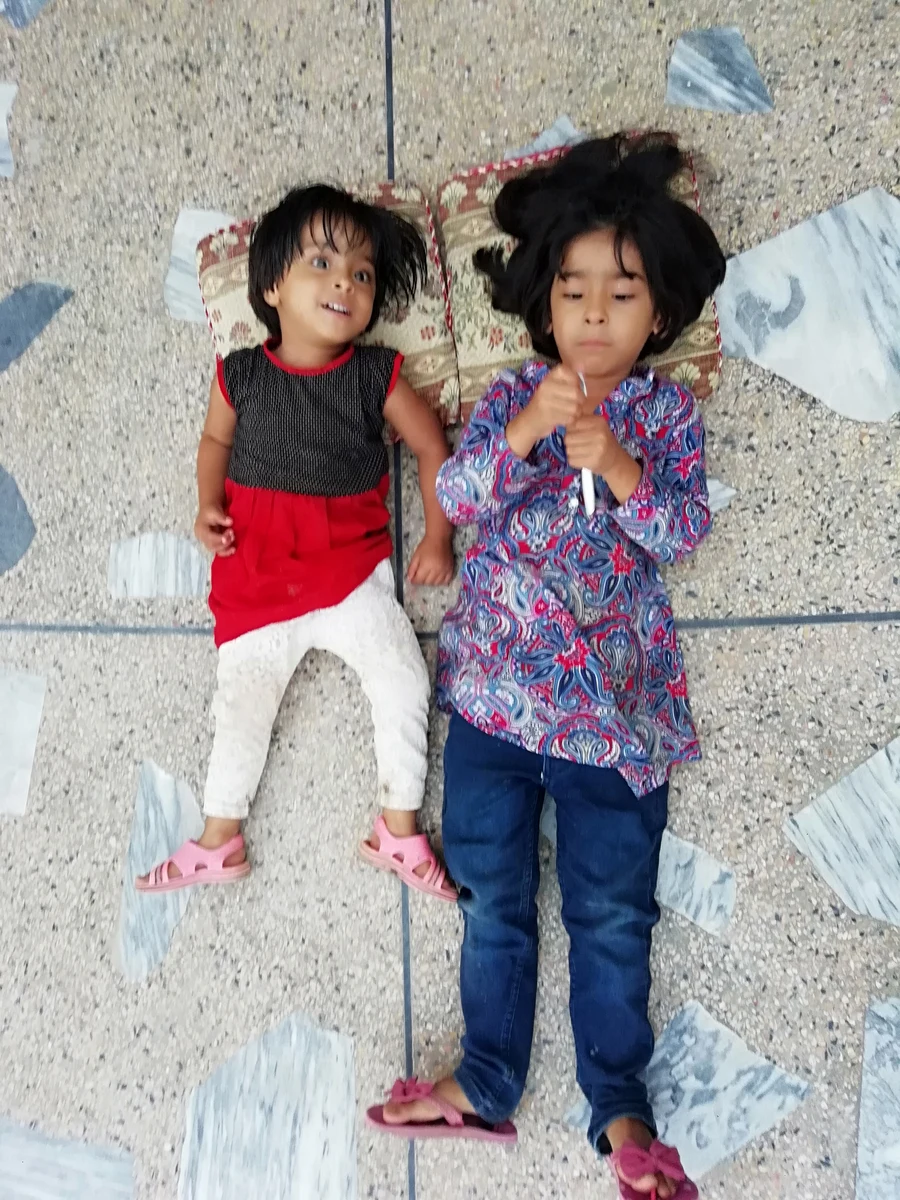 Portrait of Two Children Lying Down