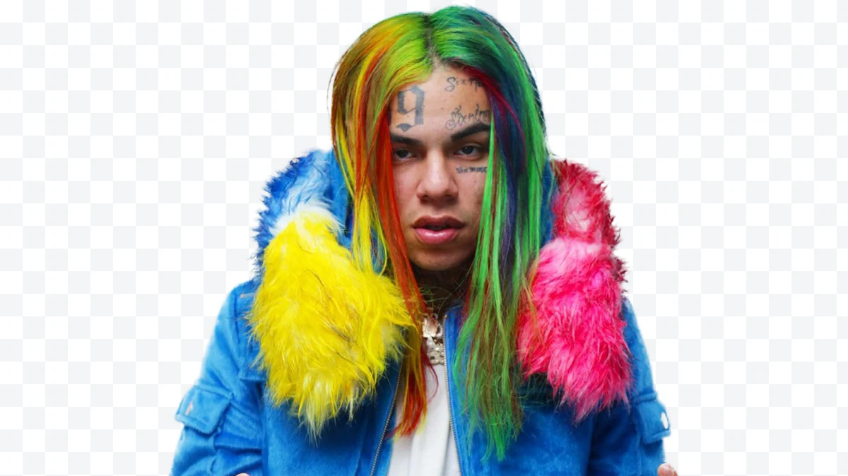 Tekashi 6ix9ine with multicolored hair and blue jacket with fur collar