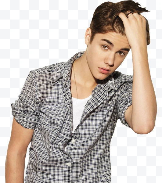 Justin Bieber joven con camisa a cuadros y camiseta blanca tocándose el cabello
